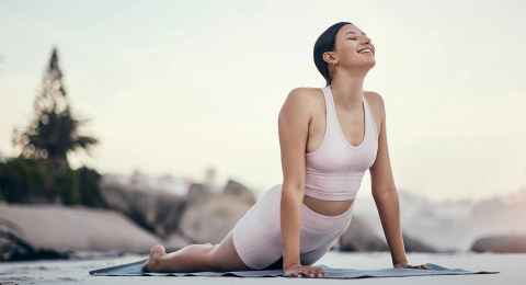 stretching-yoga-and-woman-2-on-a-beach-floor-for-we-2023-02-25-00-49-08-utc