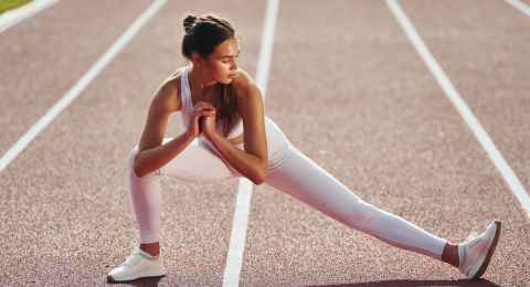 conception of fitness. young woman in sportive clothes is exercising outdoors