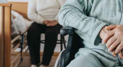 senior man after stroke sits in a wheelchair at a nursing home