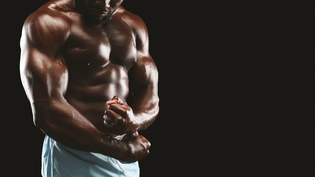 strong biceps and chest of black bodybuilder