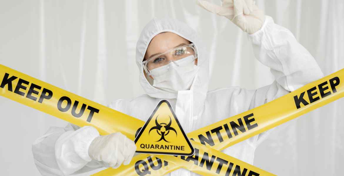 epidemiologist woman in protective clothing is in a restricted area with a danger sign. yellow line keep out quarantine. quarantine alert sign. entrance is forbidden in quarantine zone