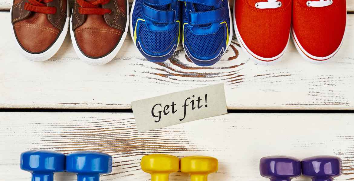 sneakers, dumbbells and motivation card.