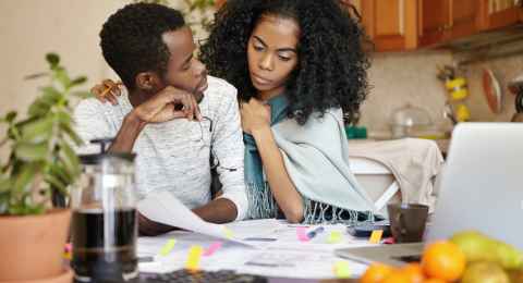 people, relationships, financial stress and economic crisis concept. young bankrupt african male telling his unhappy wife that he is no longer able to cover family expenses because of no money