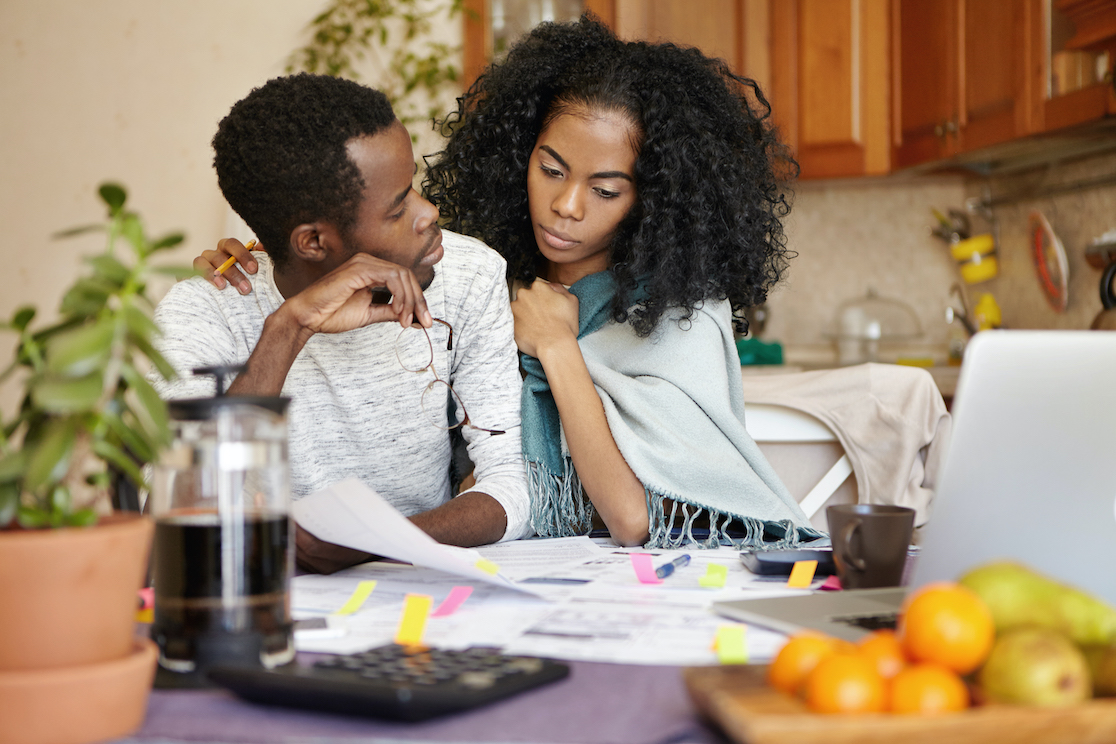 people, relationships, financial stress and economic crisis concept. young bankrupt african male telling his unhappy wife that he is no longer able to cover family expenses because of no money