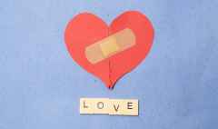 abstract concept of love. broken paper heart with medical health patch.