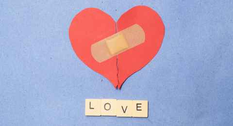 abstract concept of love. broken paper heart with medical health patch.