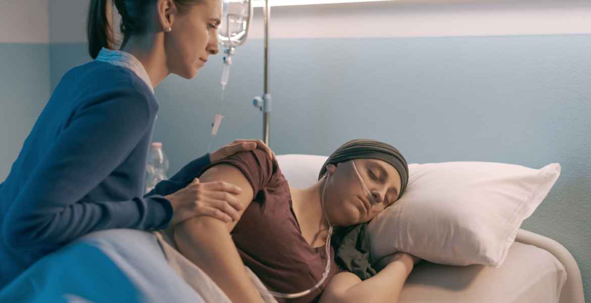 woman assisting her friend with cancer at the hospital