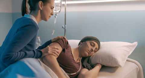 woman assisting her friend with cancer at the hospital