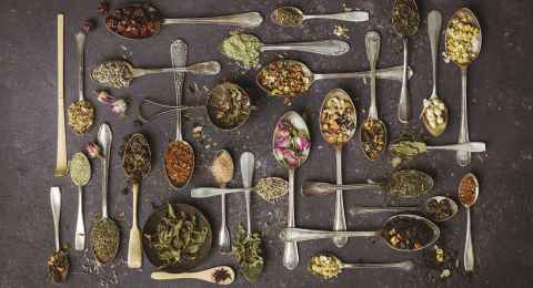 assortment of dry tea in vintage spoons