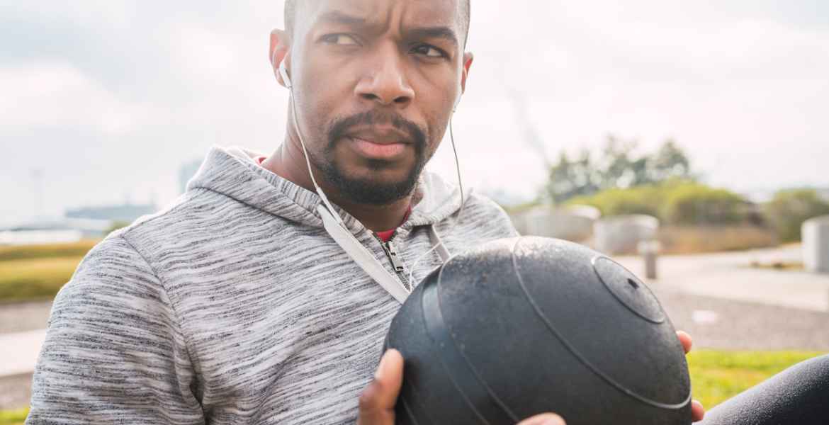 athletic man doing exercise with medicine ball.