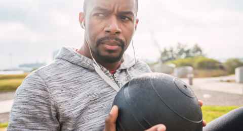 athletic man doing exercise with medicine ball.