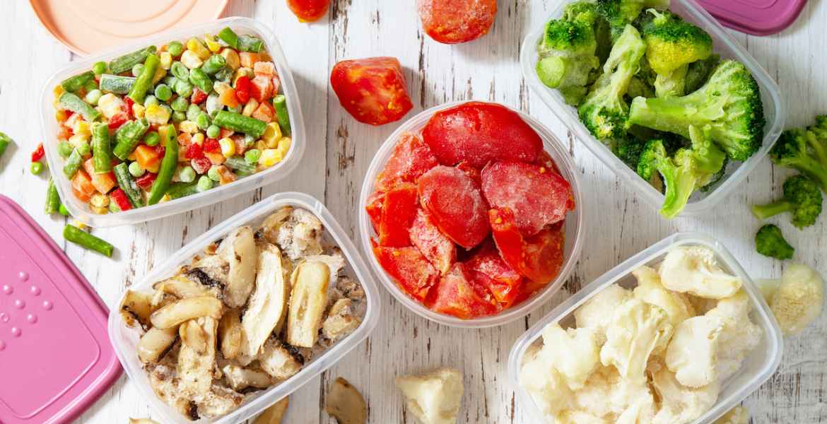 stocks of food for the winter. container with frozen vegetables and mushrooms. top view flat lay background