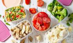 stocks of food for the winter. container with frozen vegetables and mushrooms. top view flat lay background