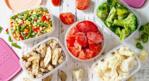 stocks of food for the winter. container with frozen vegetables and mushrooms. top view flat lay background